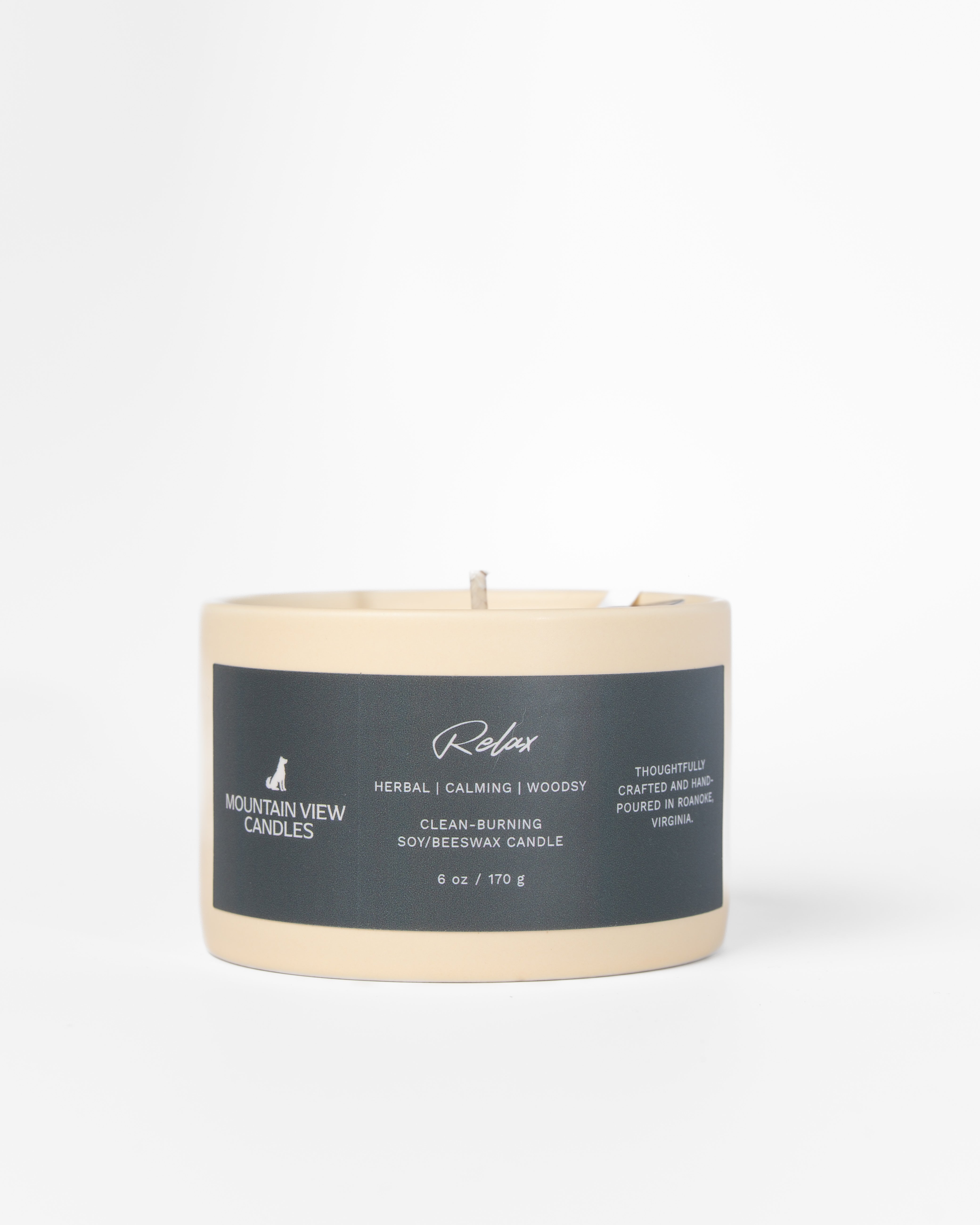 Candle with a label on a light gray background