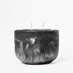 Black marbled candle with two wicks on a white background