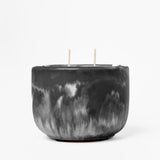 Black marbled candle with two wicks on a white background