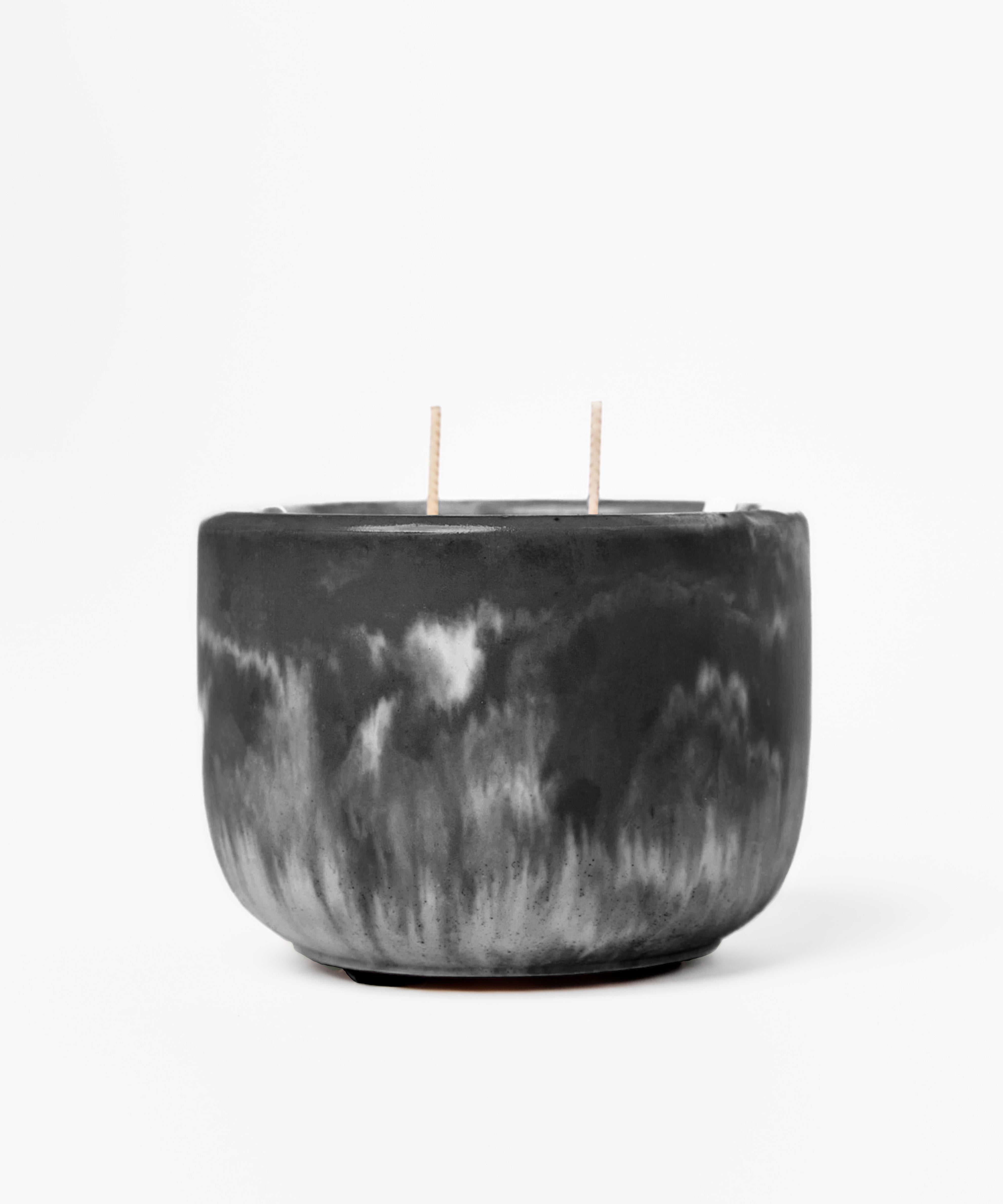 Black marbled candle with two wicks on a white background