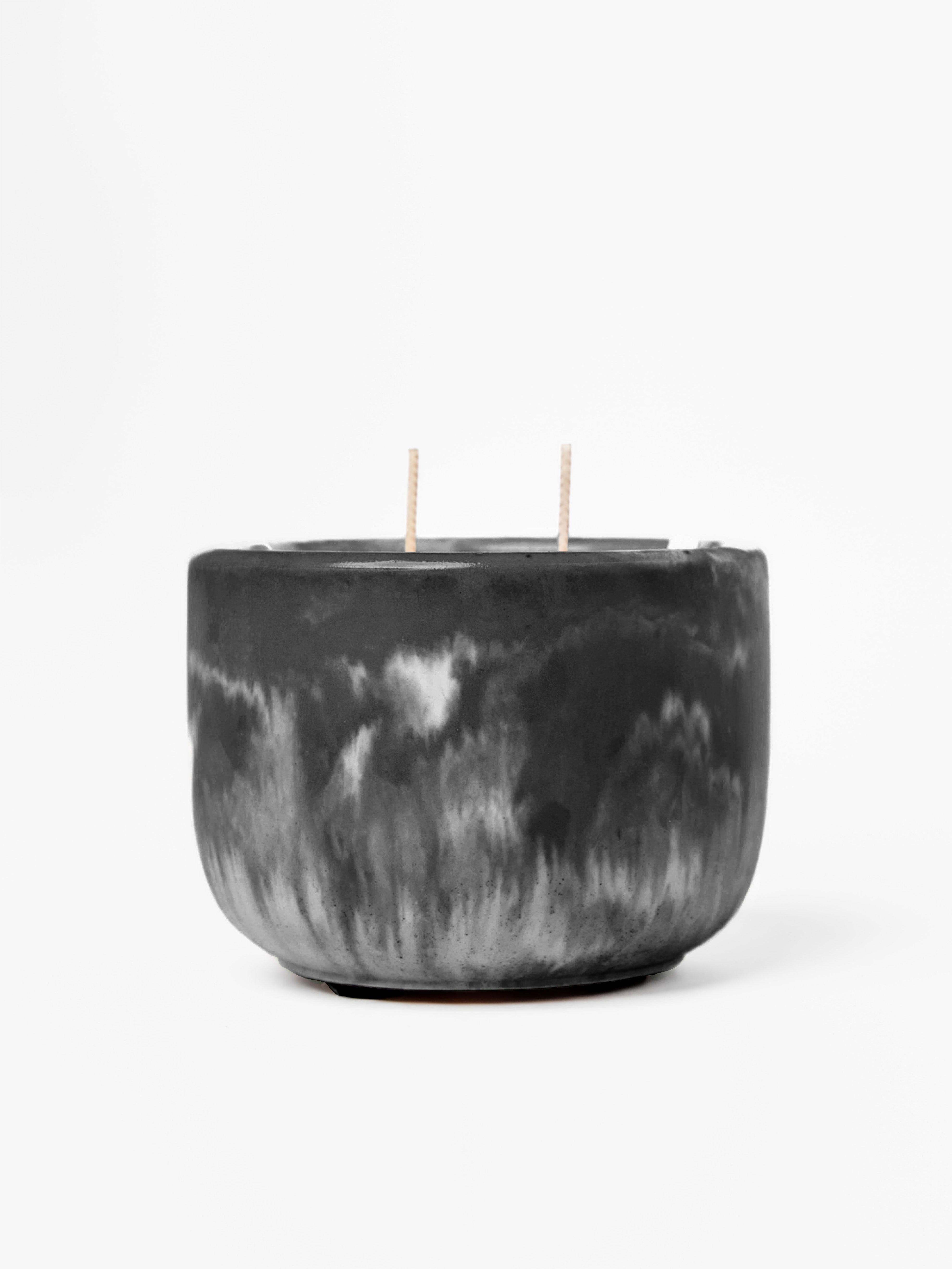 Black marbled candle with two wicks on a white background