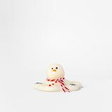 Small white snowman wax melt with a red bow on a white background