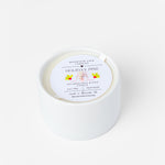 White candle with a label on a white background