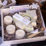 Gift set with candles, soap, and other items in a box labeled 'Winter Collection'.