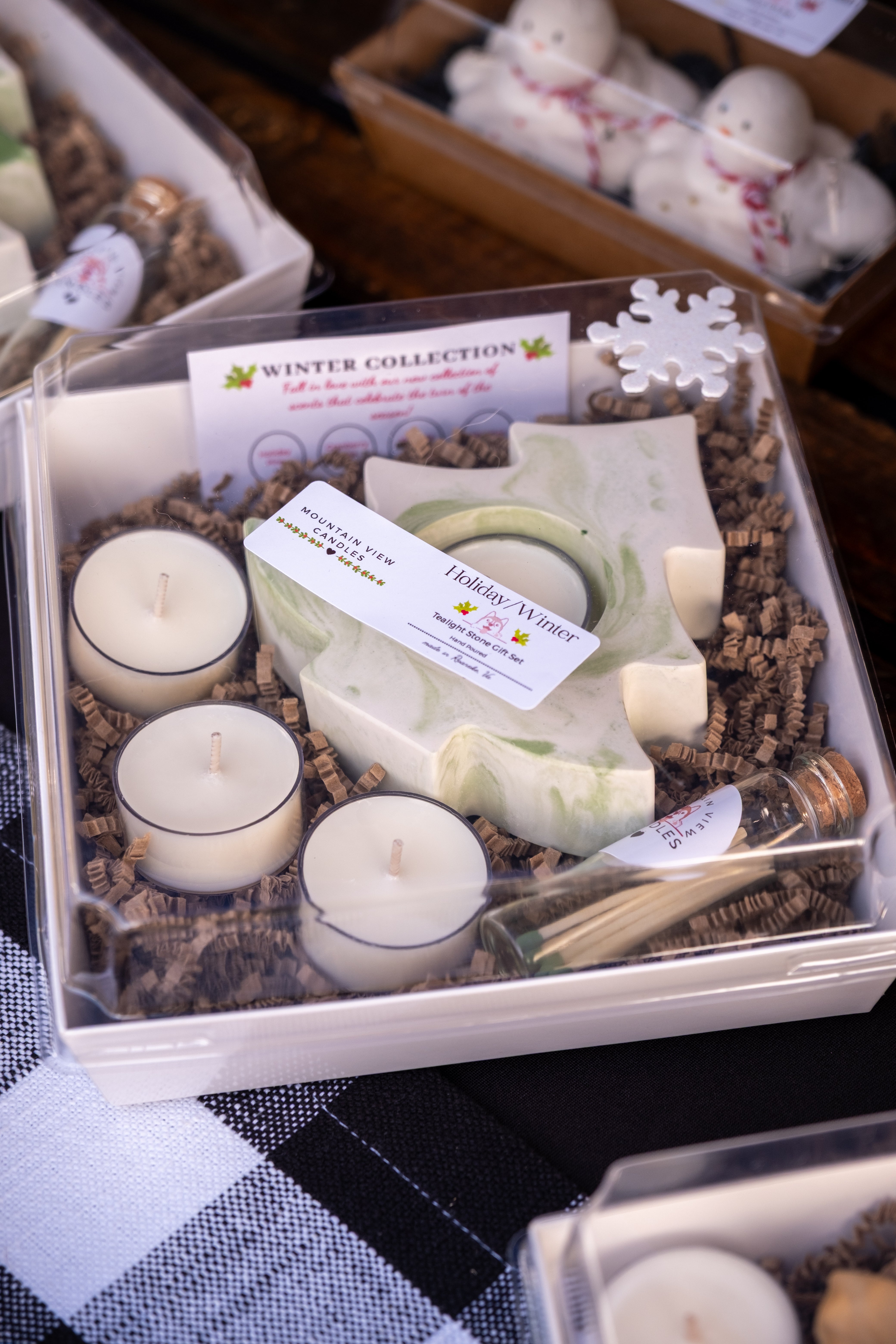 Gift set with candles, soap, and other items in a box labeled 'Winter Collection'.