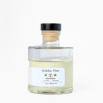 Bottle of 'Holiday Pine' diffuser on a white background