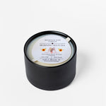 Black candle with a label on a white background