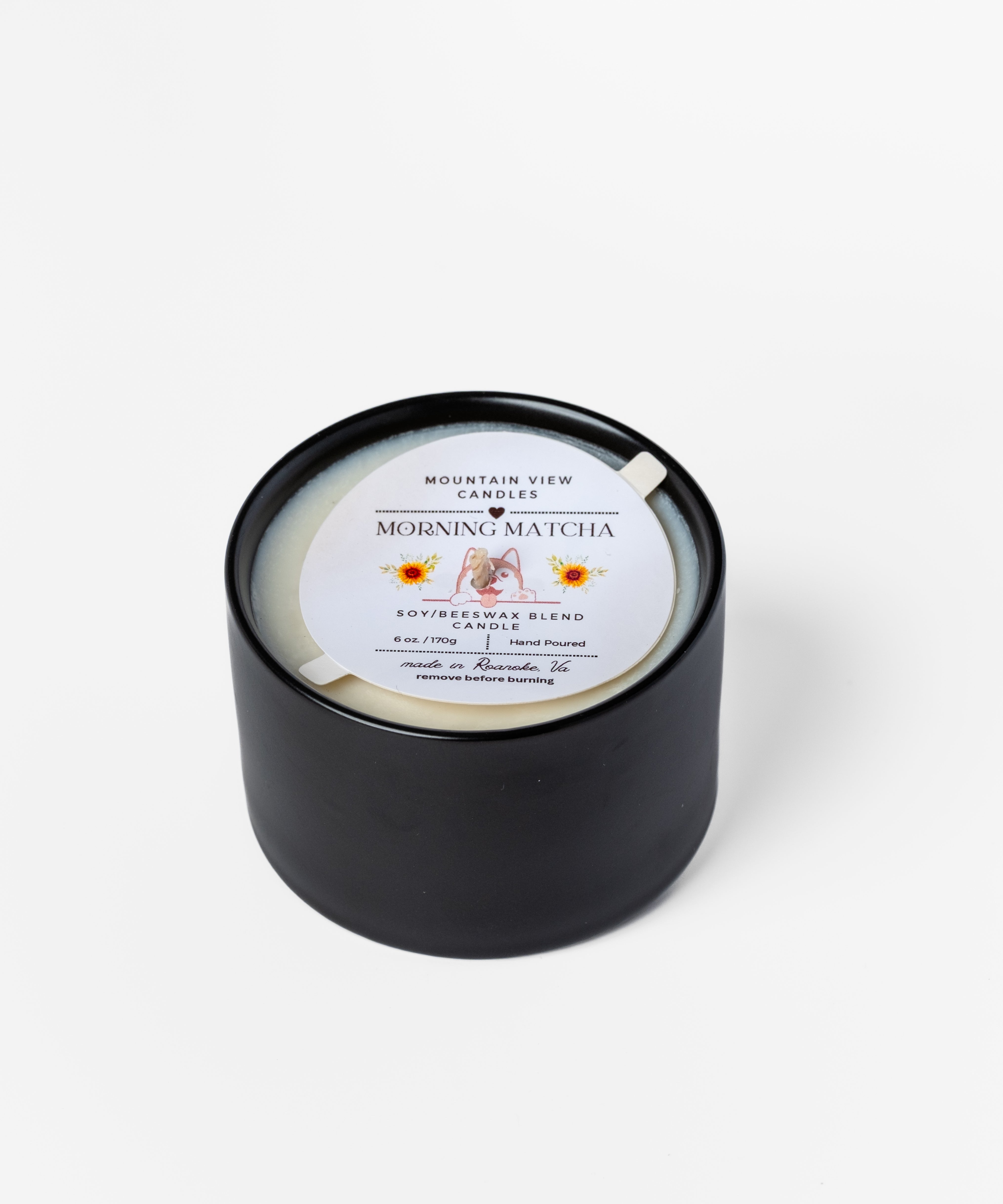 Black candle with a label on a white background