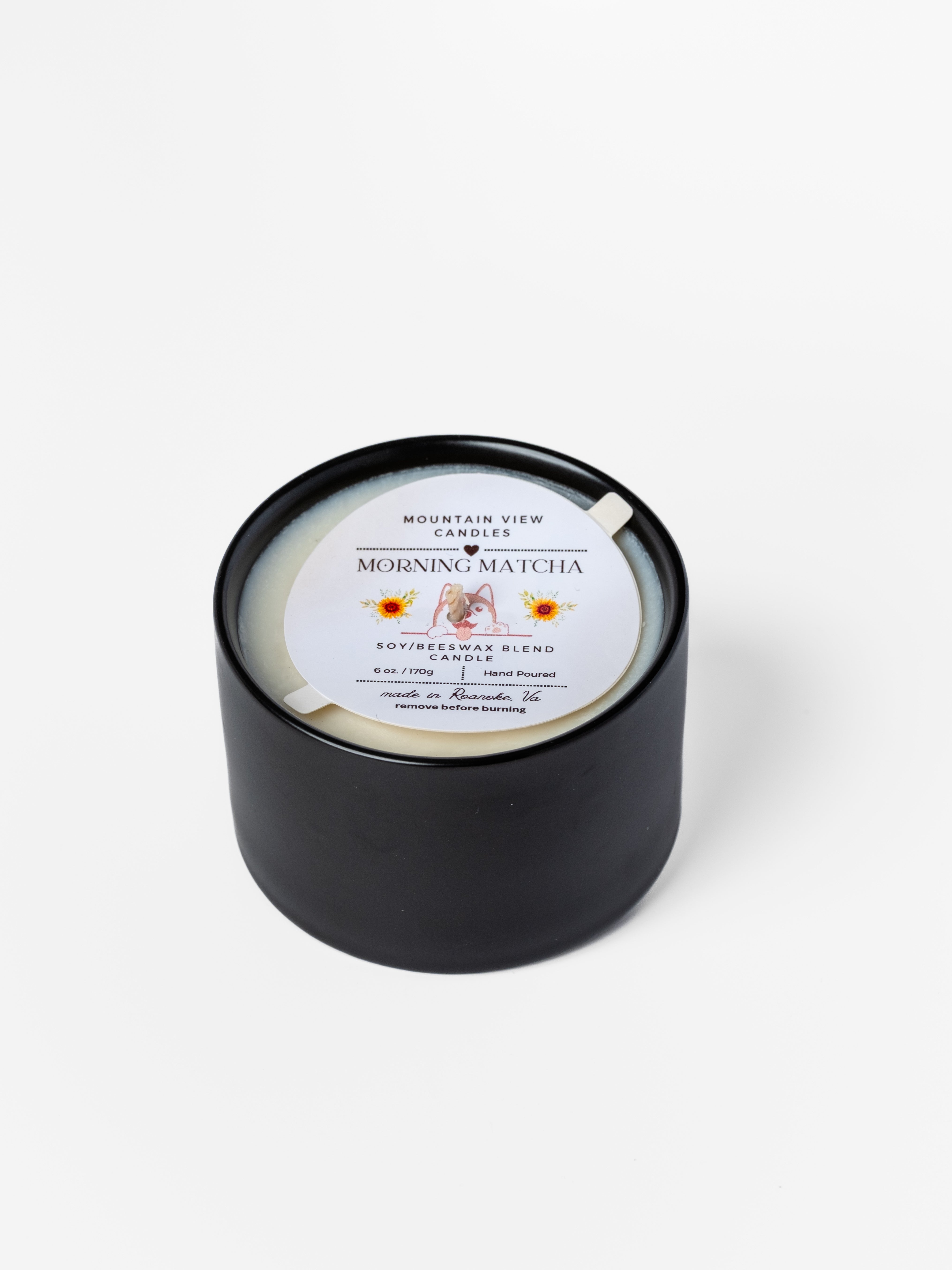 Black candle with a label on a white background