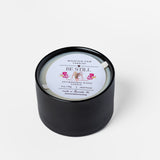 Black candle with a white label on a white background