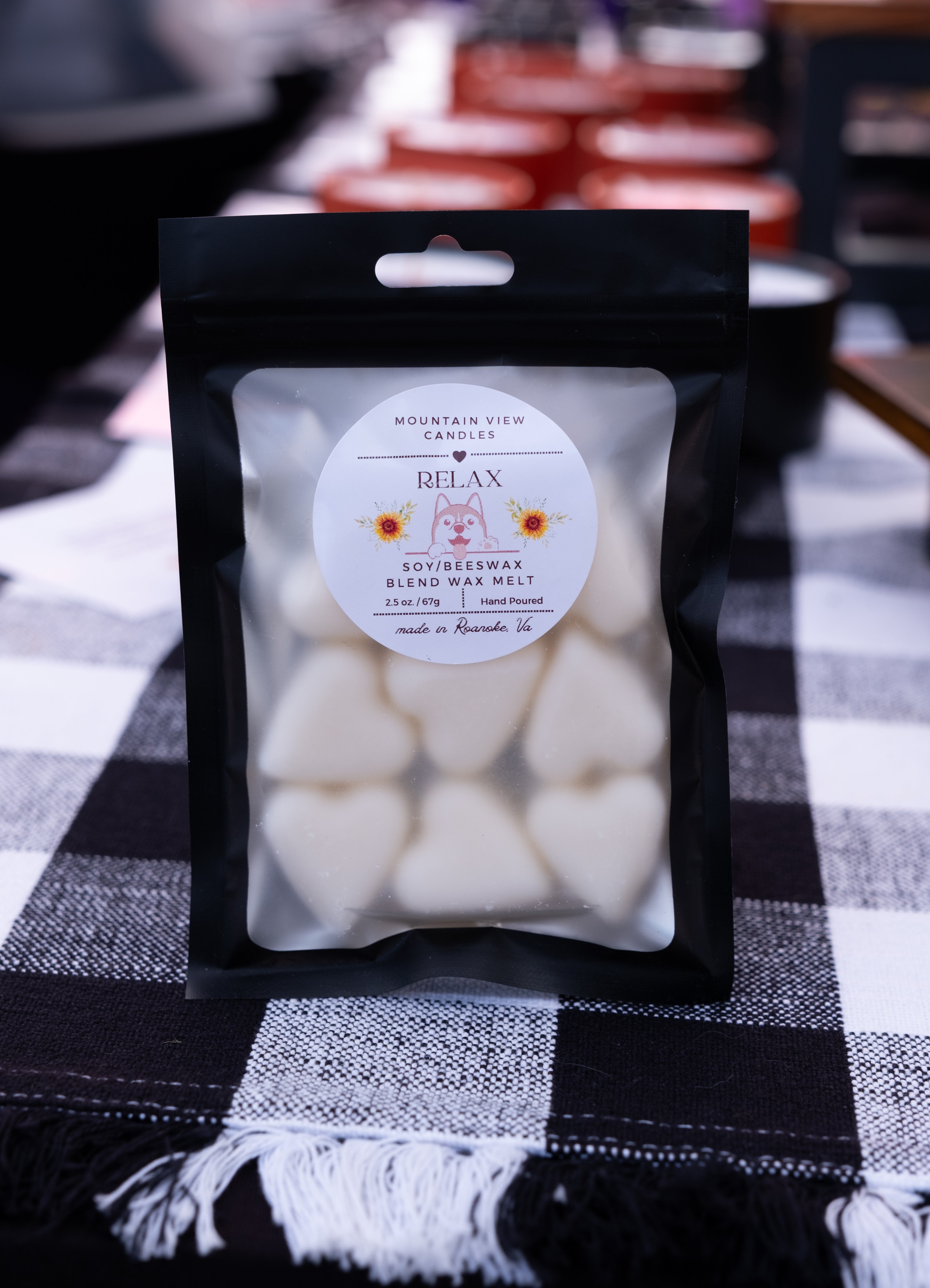 Packaged wax melts with a label on a checkered tablecloth