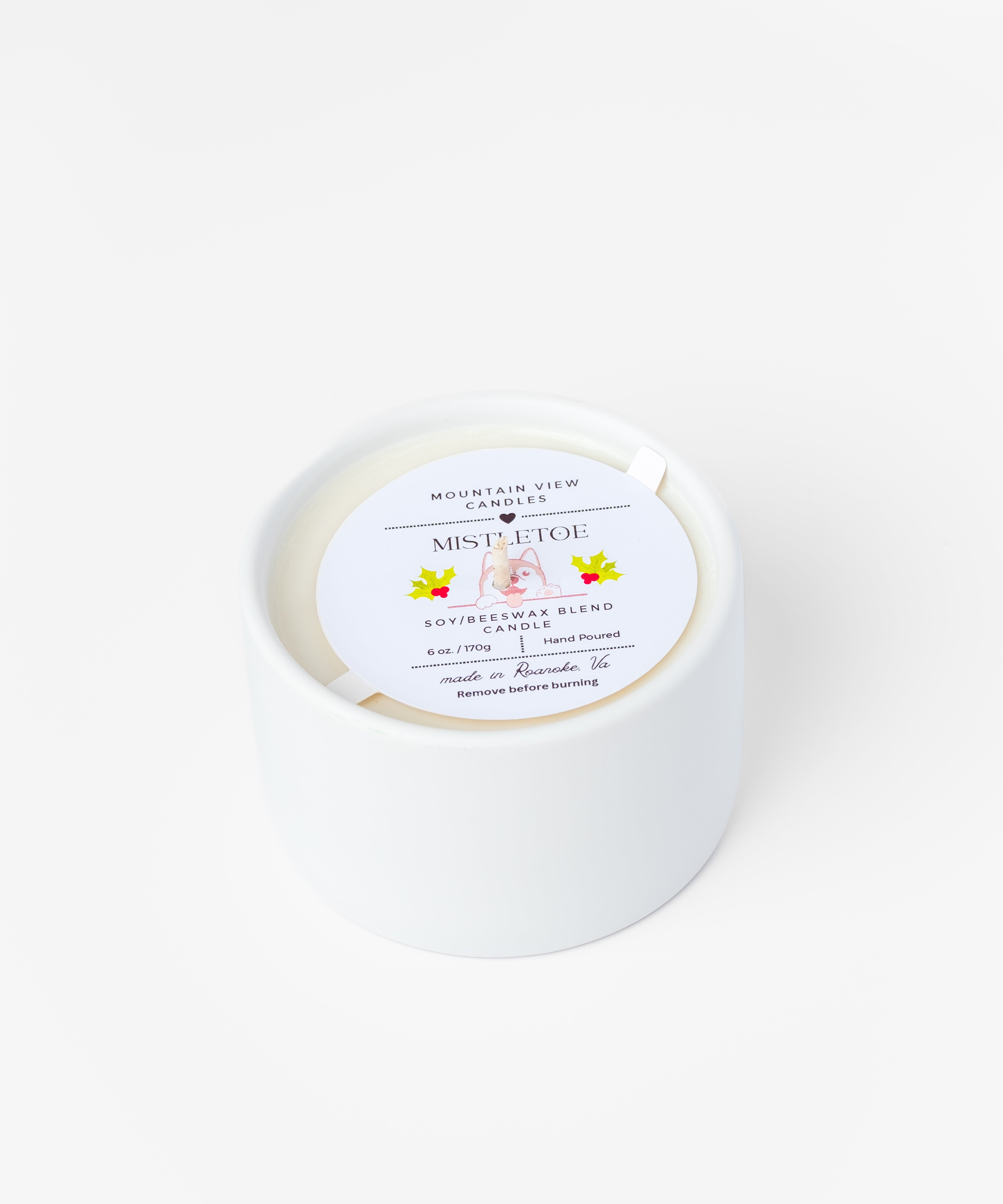 White candle with a label on a white background