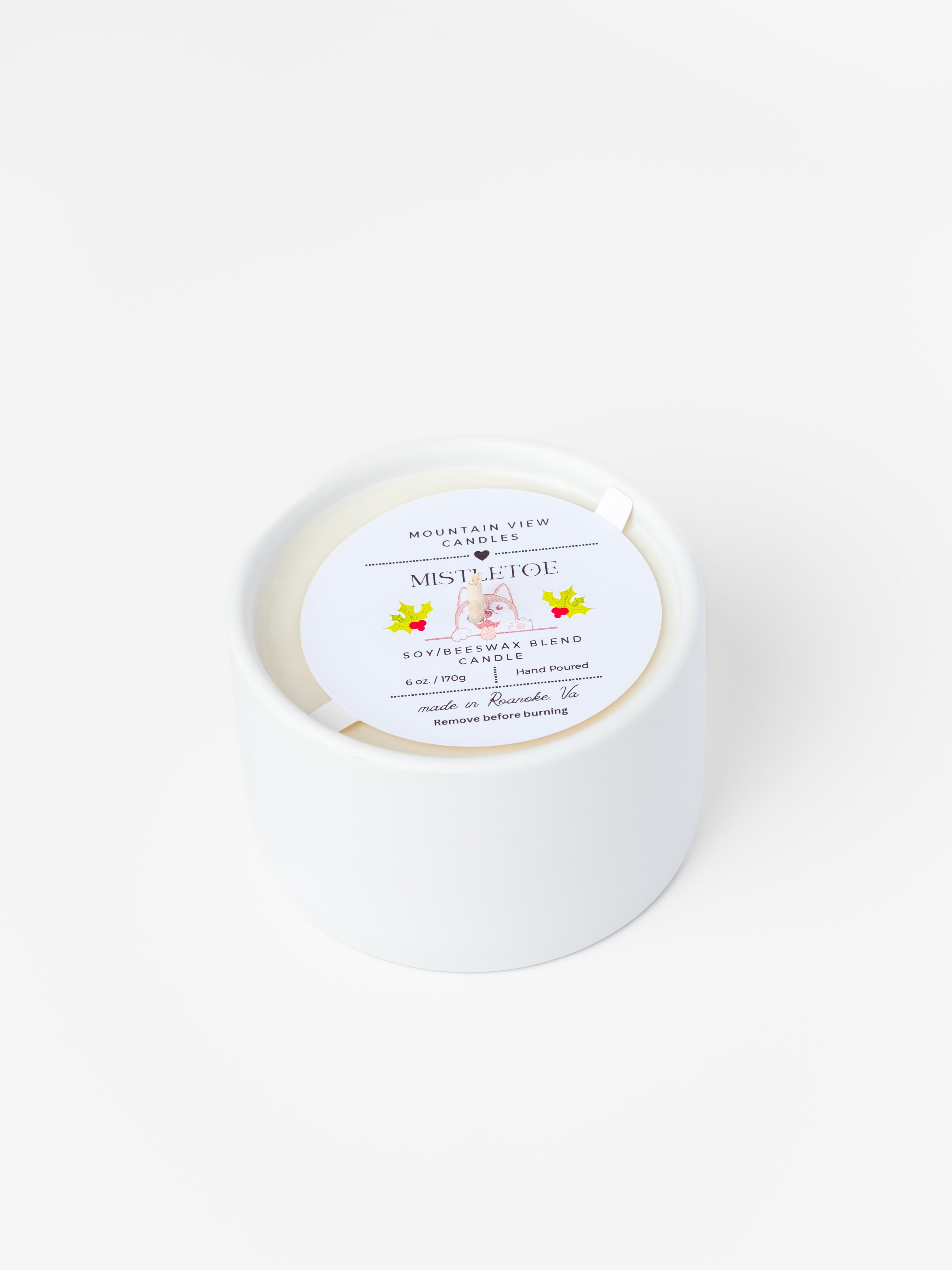 White candle with a label on a white background