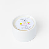 White candle with a label on a white background