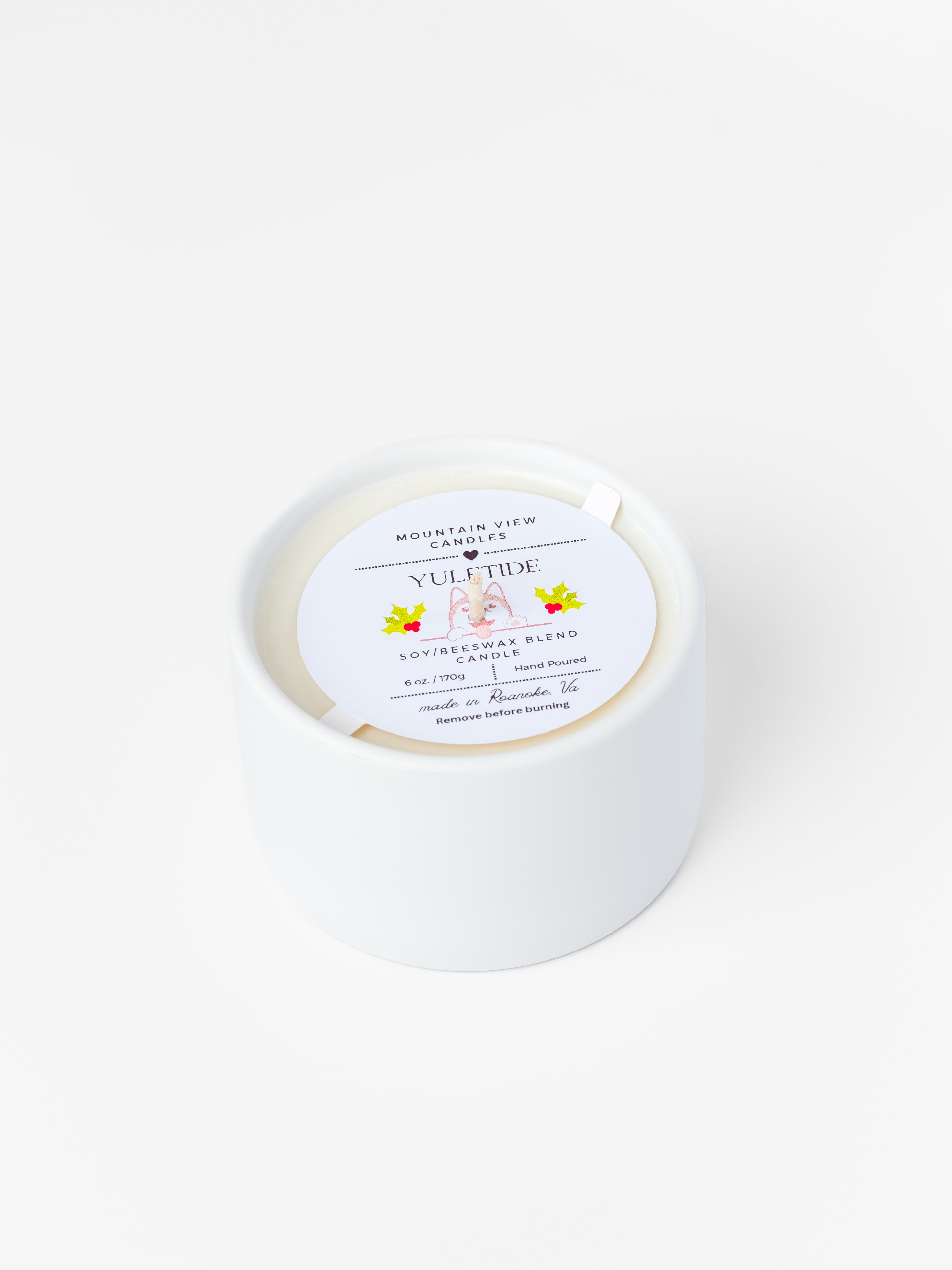 White candle with a label on a white background