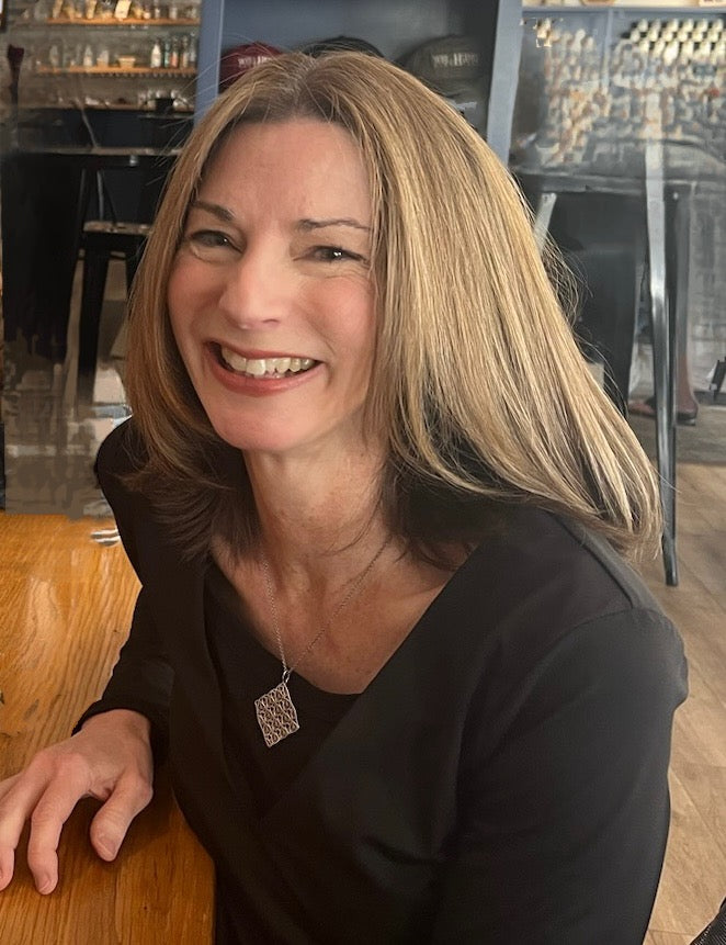 Woman sitting at a table in a restaurant setting