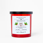 Red candle with a white label featuring a dog illustration and text on a white background