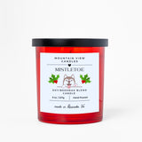 Red candle with a white label featuring a dog illustration and text on a white background