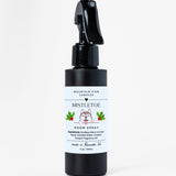 Black spray bottle with a white label on a white background
