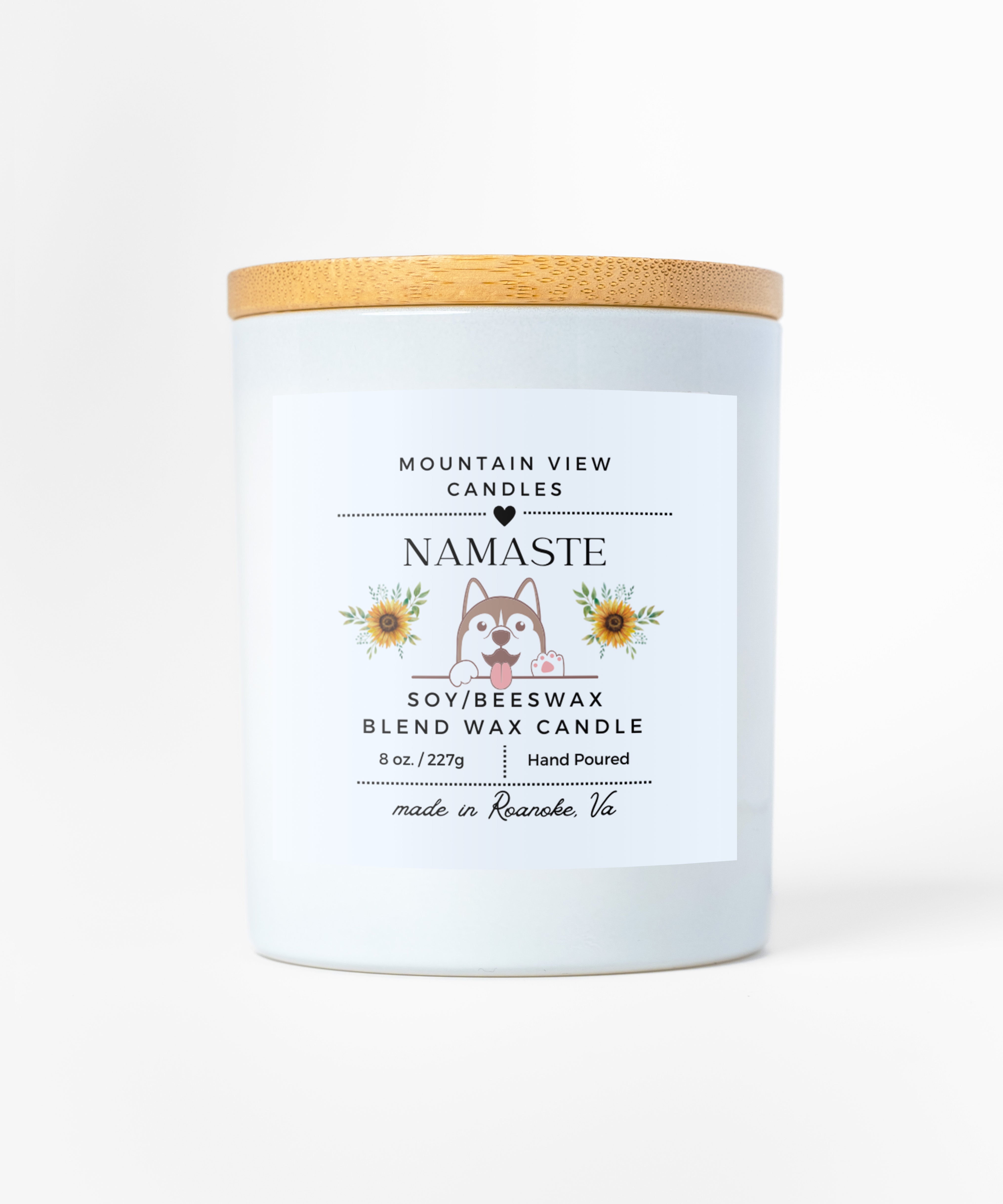 Candle with a wooden lid and 'Namaste' label on a white background