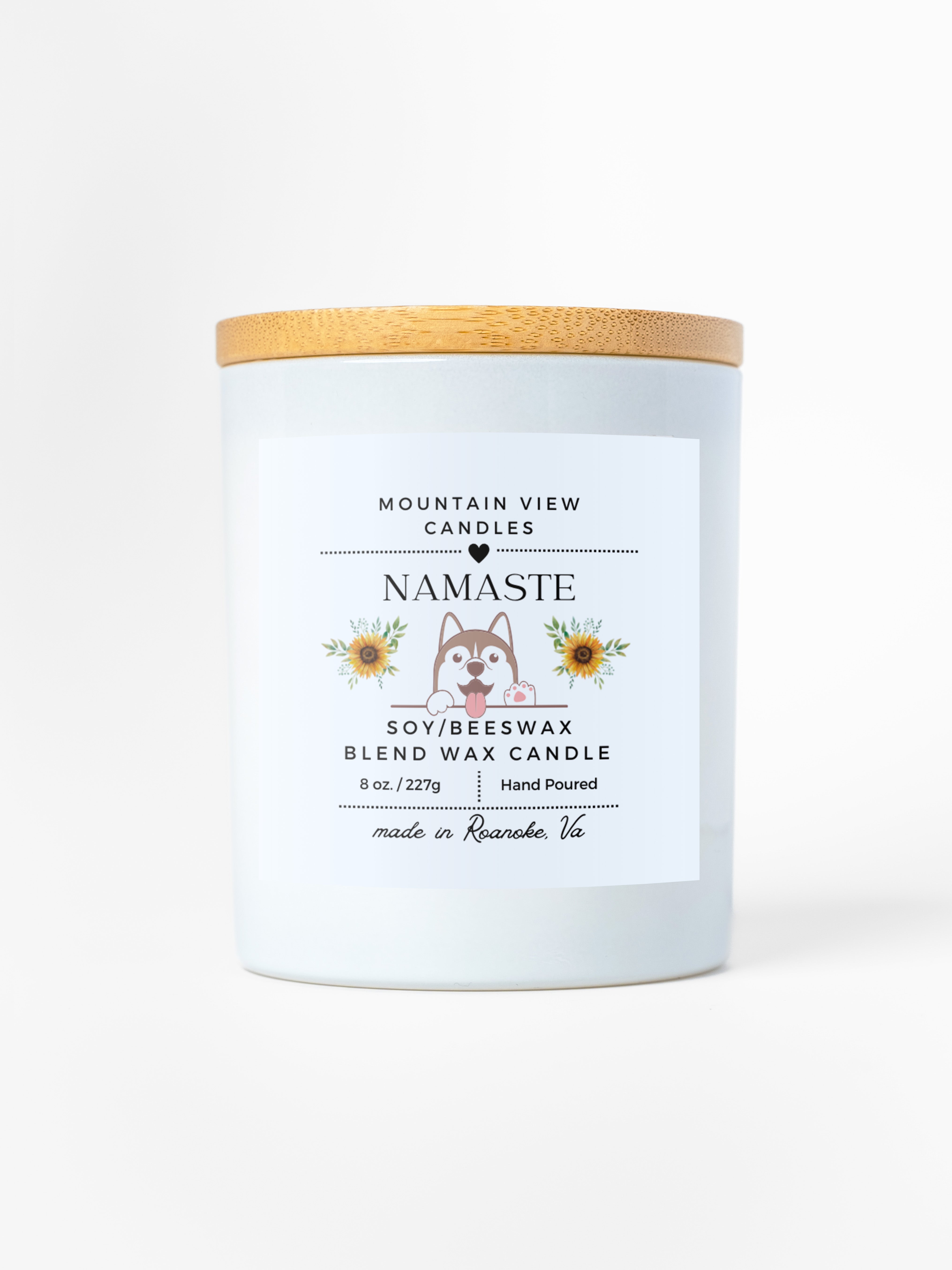 Candle with a wooden lid and 'Namaste' label on a white background