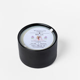 Black candle with a white label on a white background