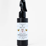 Black room spray bottle with a white label on a white background