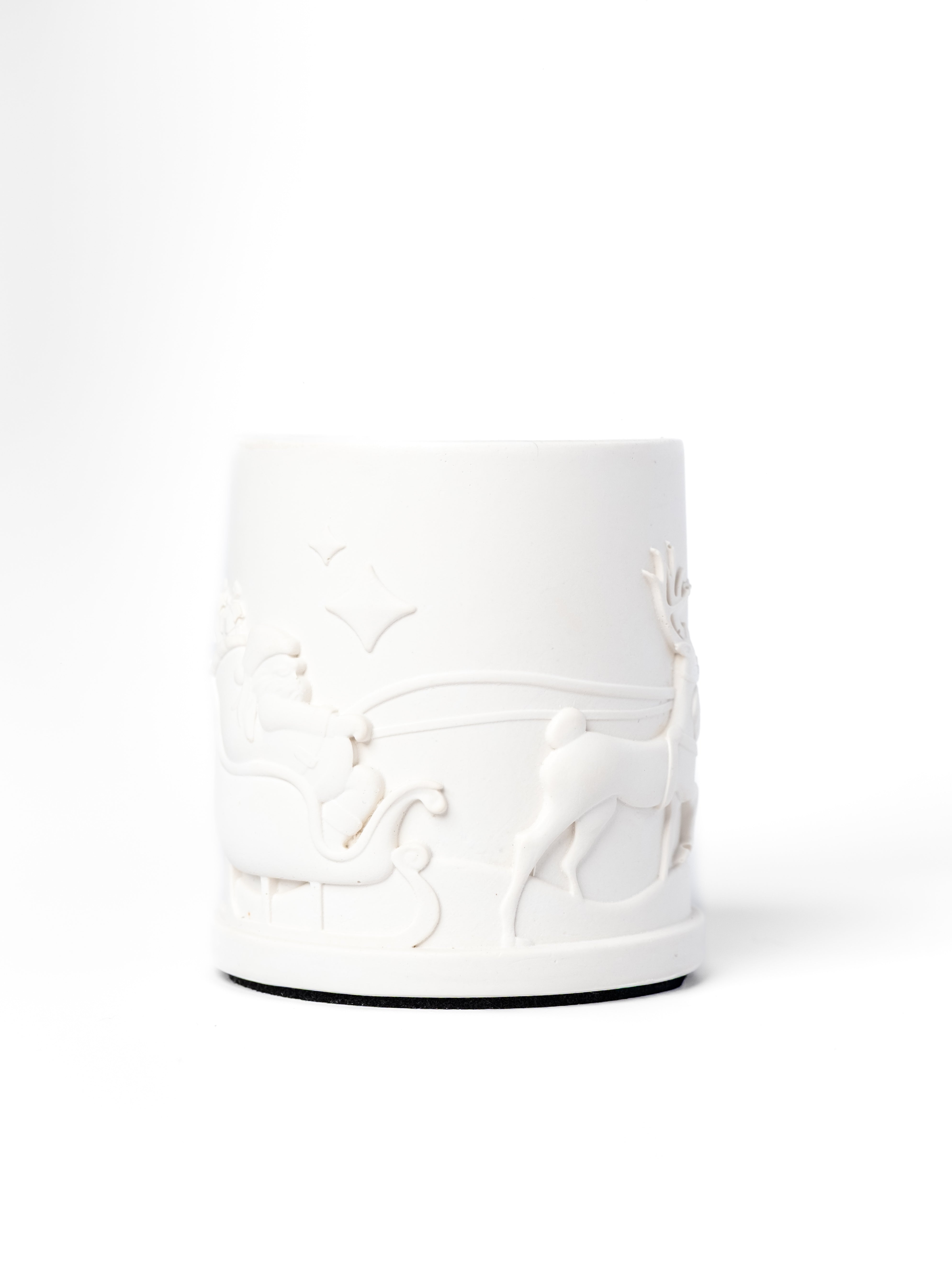 White ceramic vase with embossed design on a white background