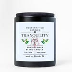 Candle with 'Tranquility' label on a white background