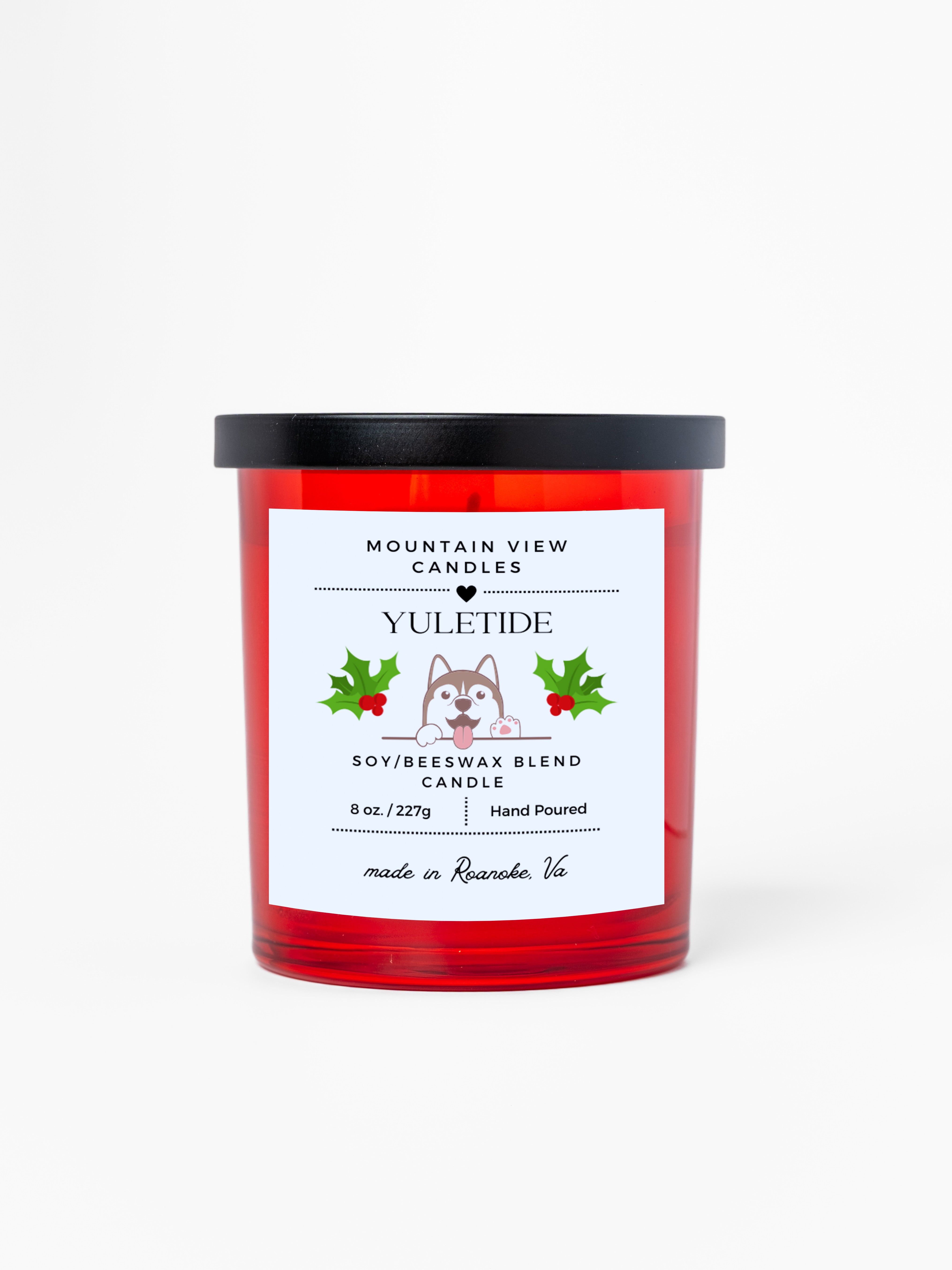 Yuletide candle with a label featuring a dog illustration on a white background